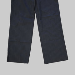 Two grey striped pant legs fabric on a tiled floor