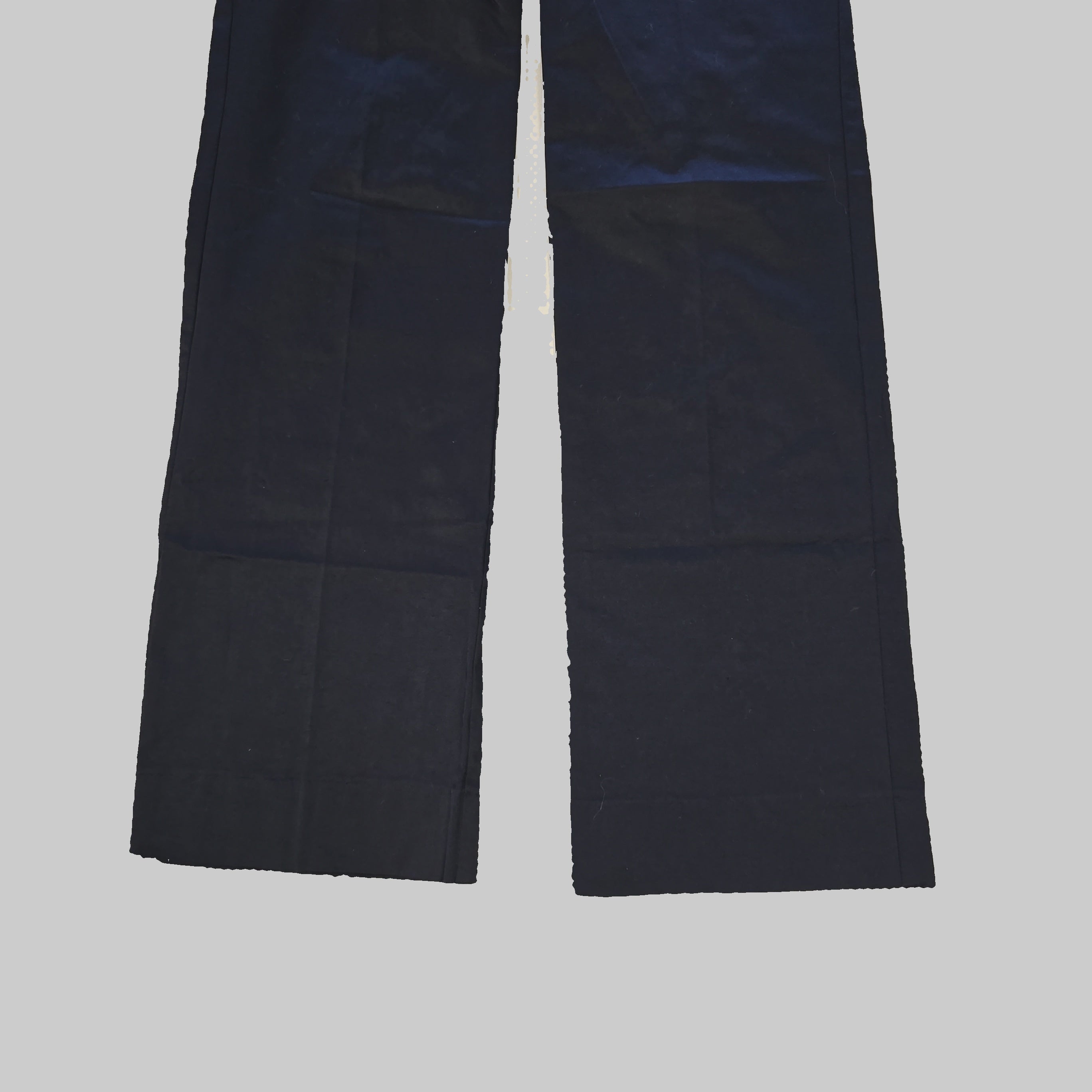 Pair of black pantlegs laid flat on a tiled floor