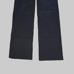 Pair of black pantlegs laid flat on a tiled floor