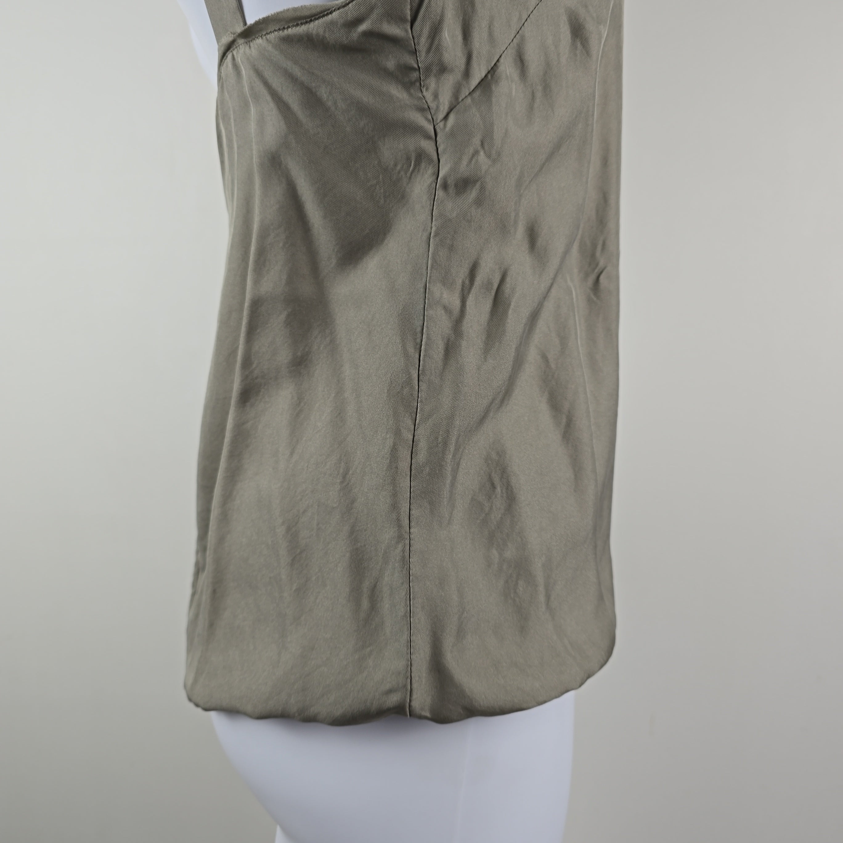 Grey fabric on a mannequin against a white background