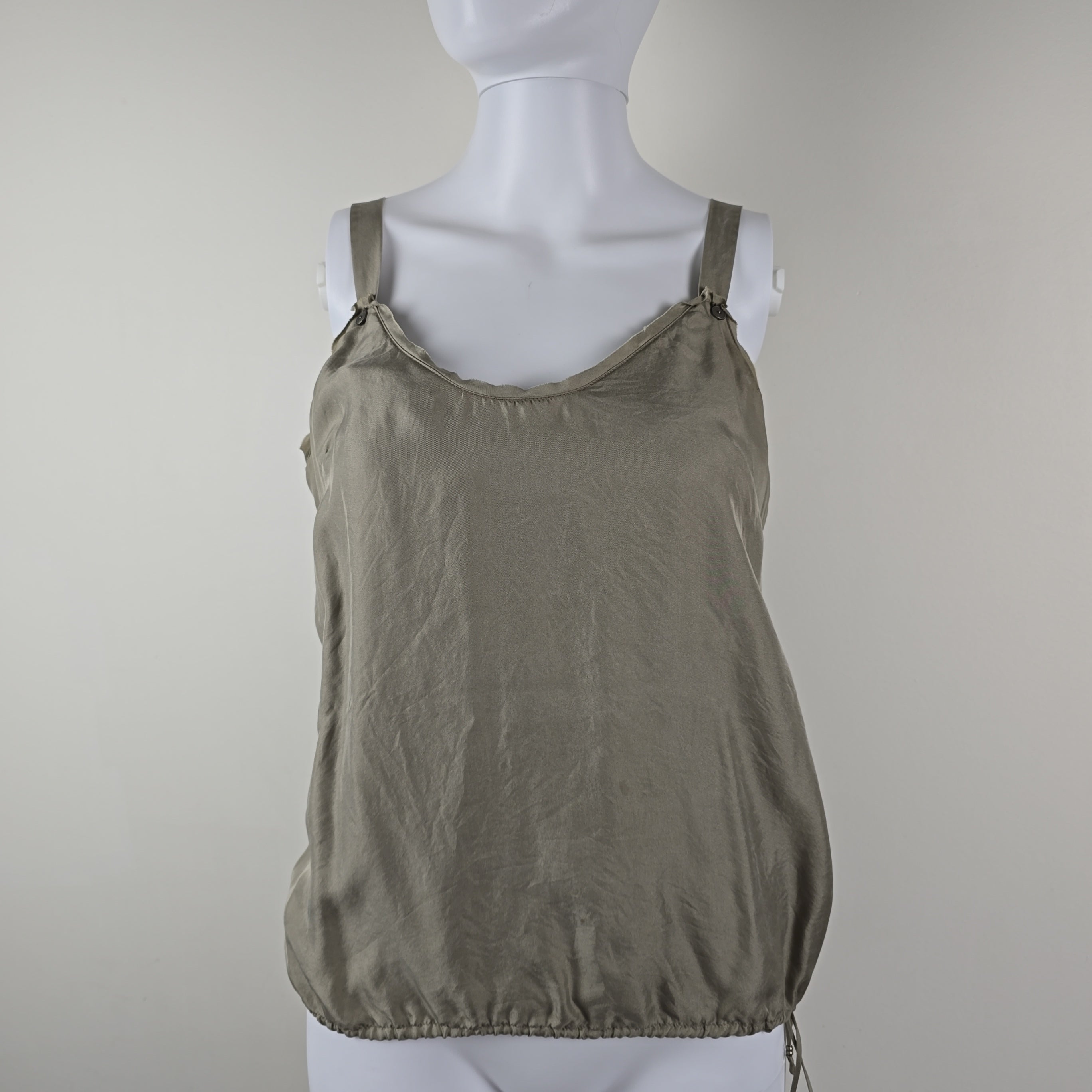 Grey tank top on a mannequin against a plain background