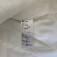 Close-up of a white garment with a visible label on a white background