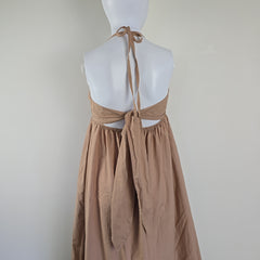 Mannequin wearing a beige dress on a plain background