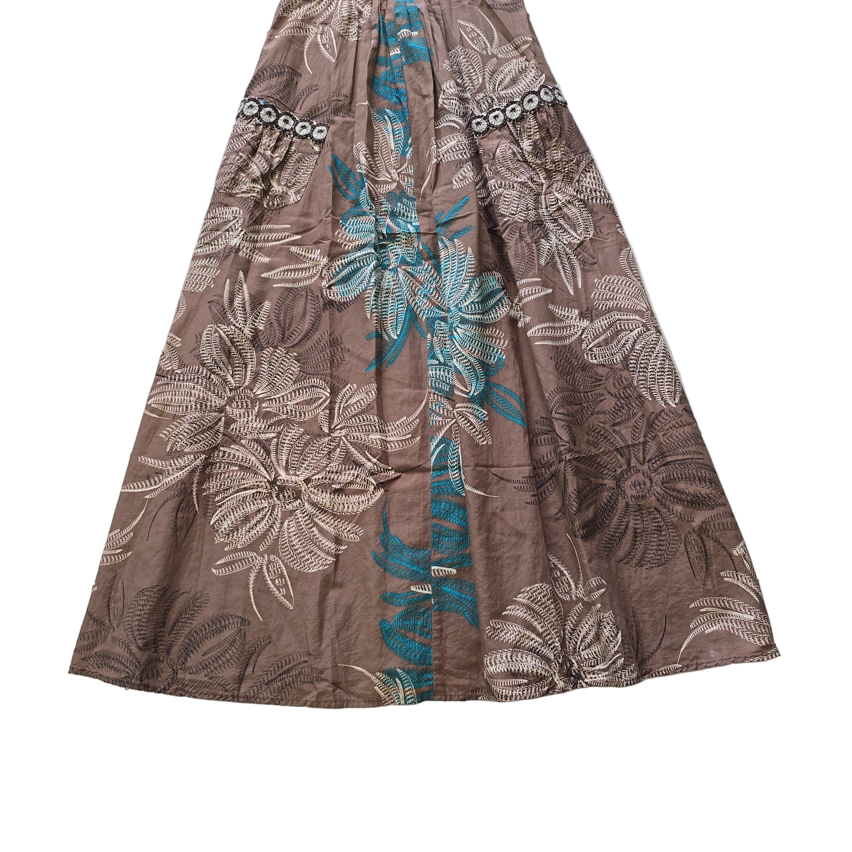 Floral patterned fabric with brown, white, and blue colors on a tiled floor.