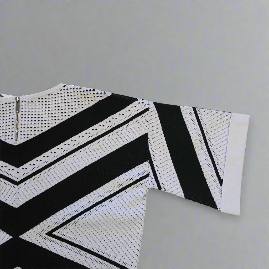 Black and white patterned top on a tiled floor