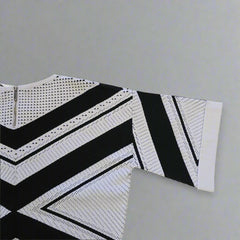 Black and white patterned top on a tiled floor