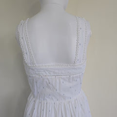 White lace dress on a mannequin against a beige background