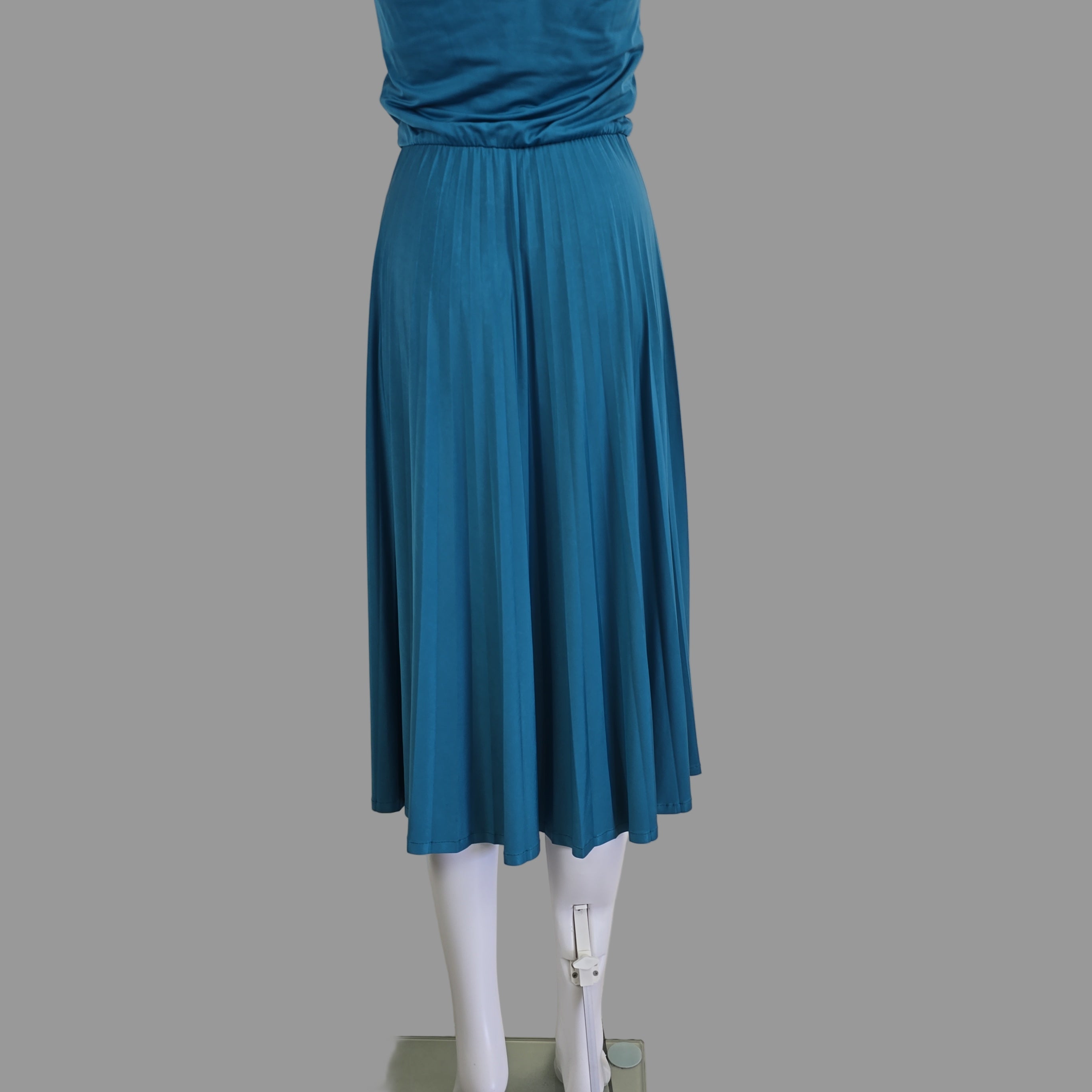 Blue pleated skirt on a white surface