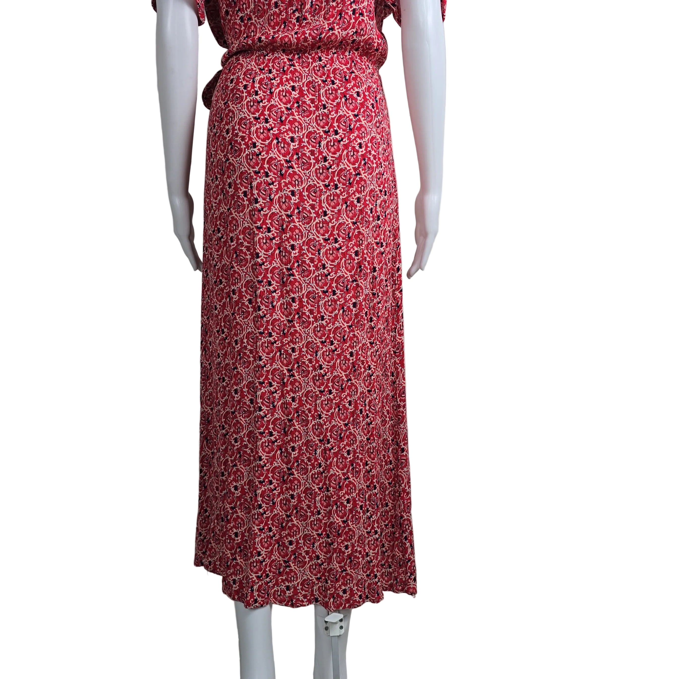 Mannequin wearing a red patterned dress against a plain background