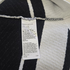 Close-up of a label on a black and white striped garment with 'Karen Millen' branding.
