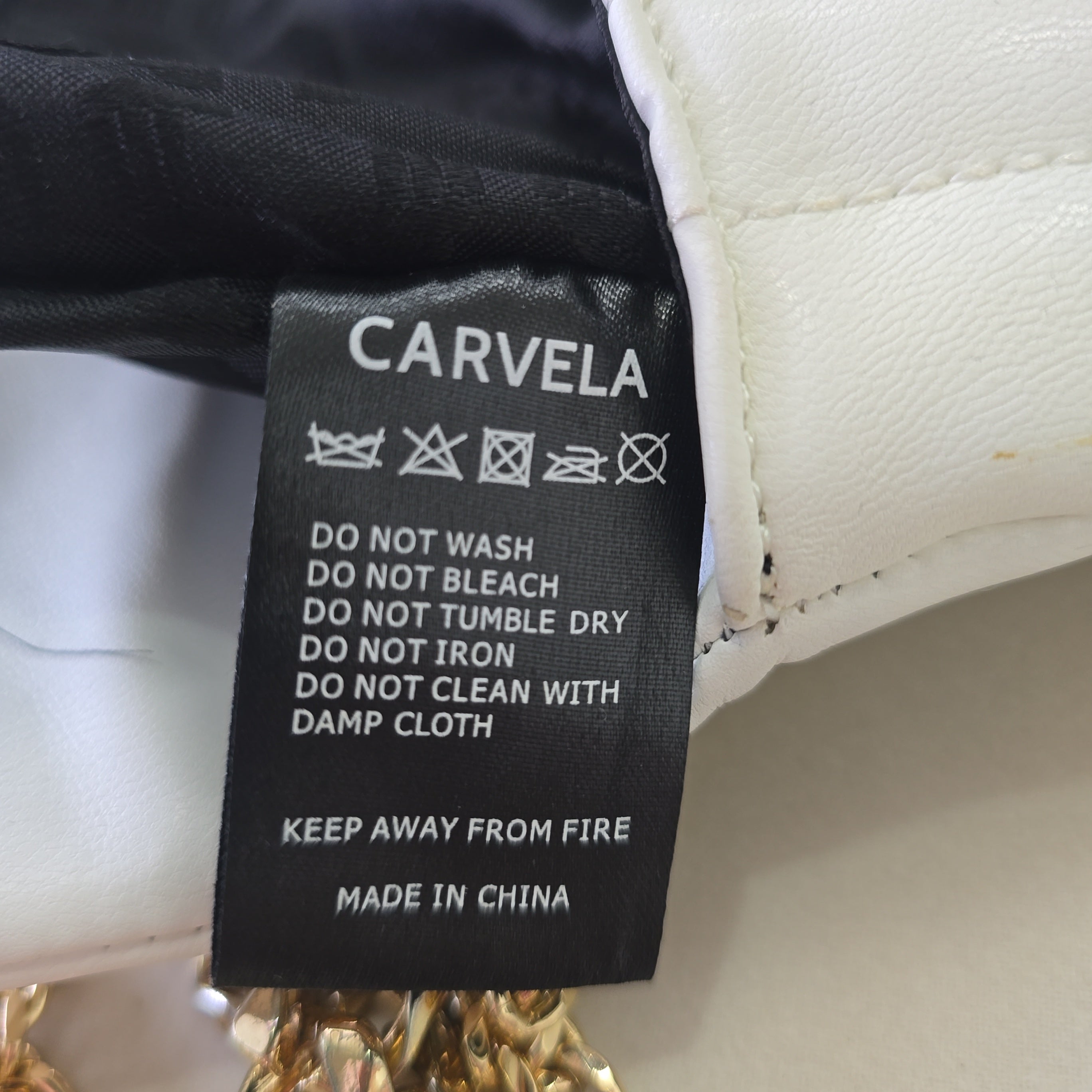Close-up of a Carvela label with care instructions.
