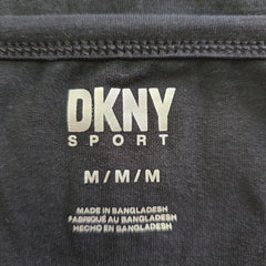 DKNY Sport label on a black fabric background
