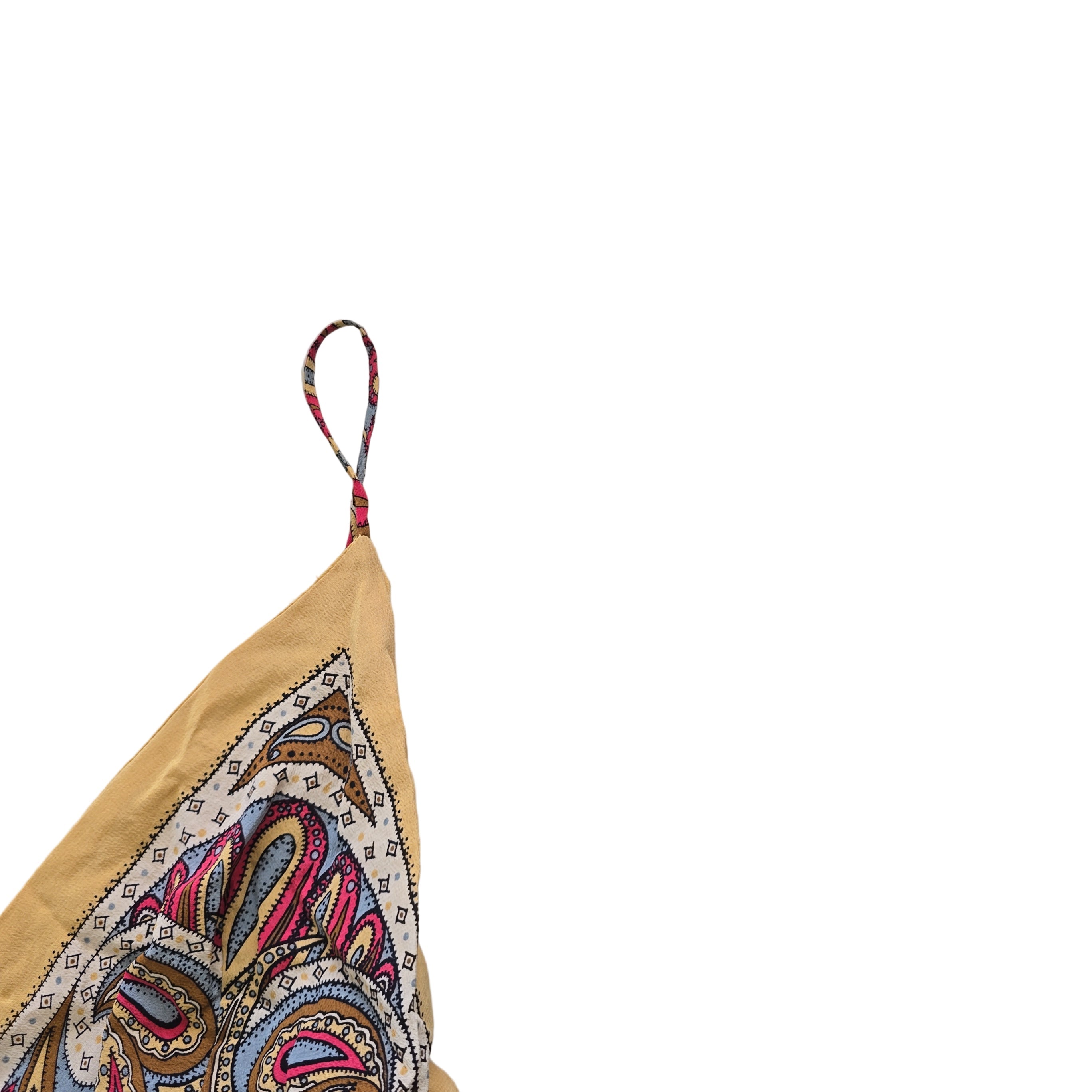 Colorful bikini top with pattern on a light gray surface