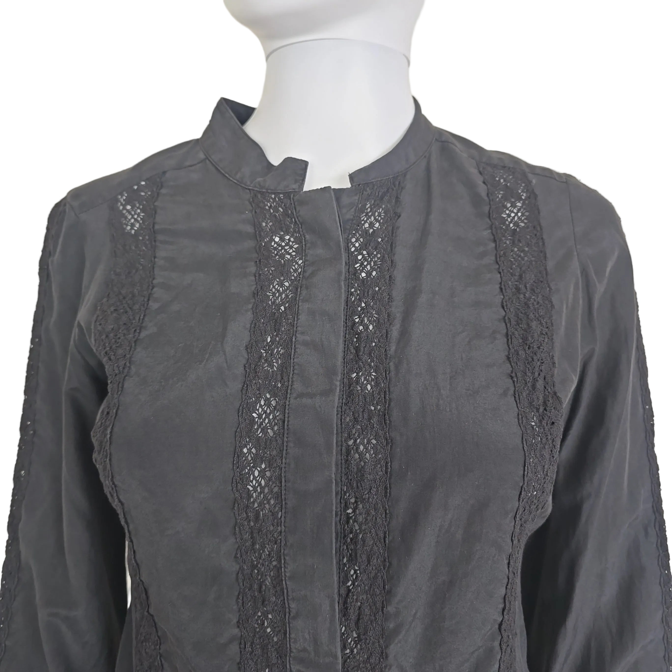 Black skirt with lace detailing on a beige background