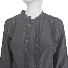 Black skirt with lace detailing on a beige background