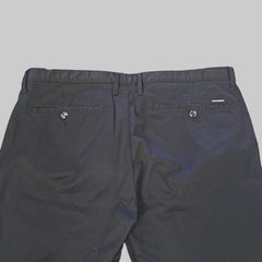 Black pants on a beige tiled floor