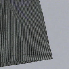 Black and white striped fabric on a tiled floor