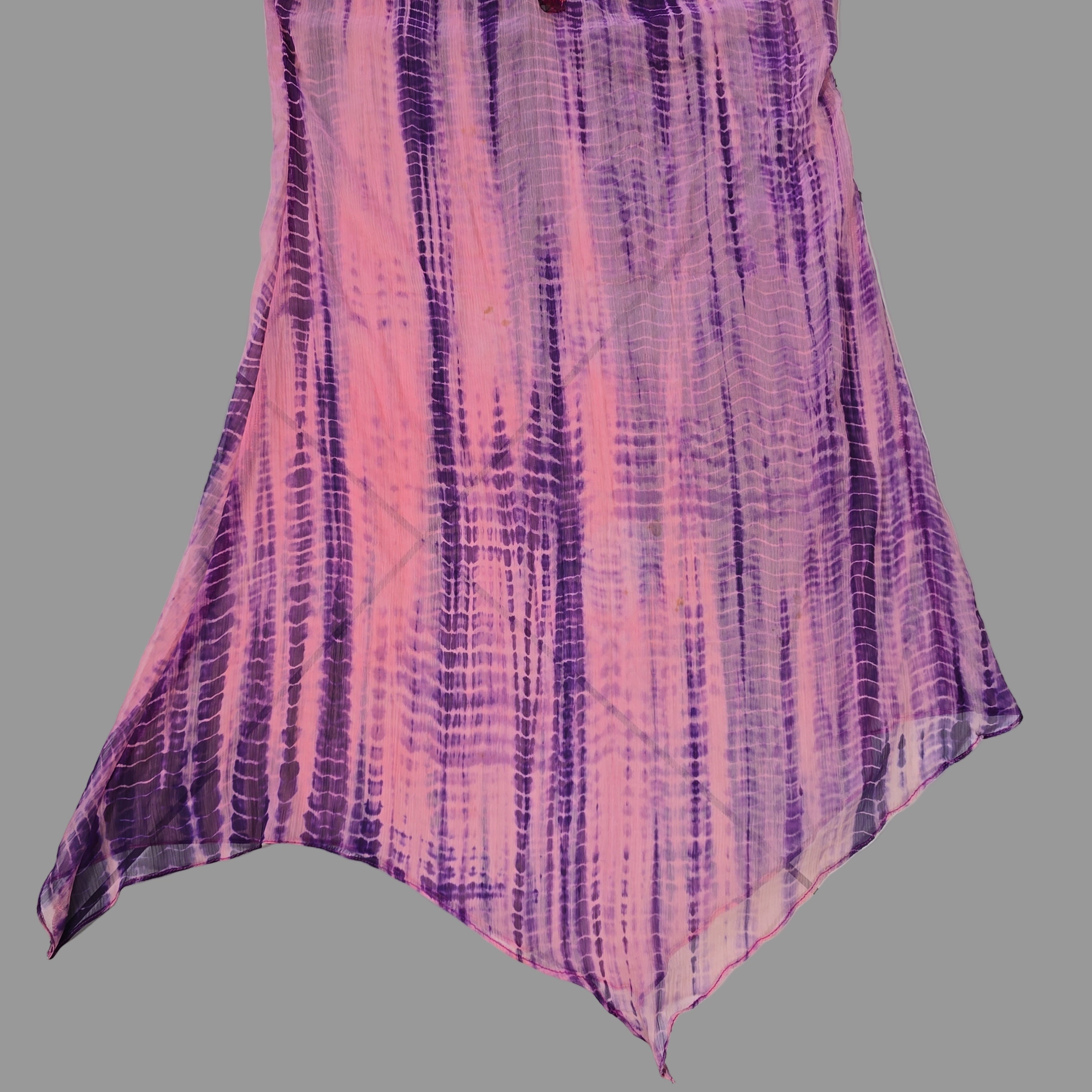 Purple and pink patterned fabric on a tiled floor