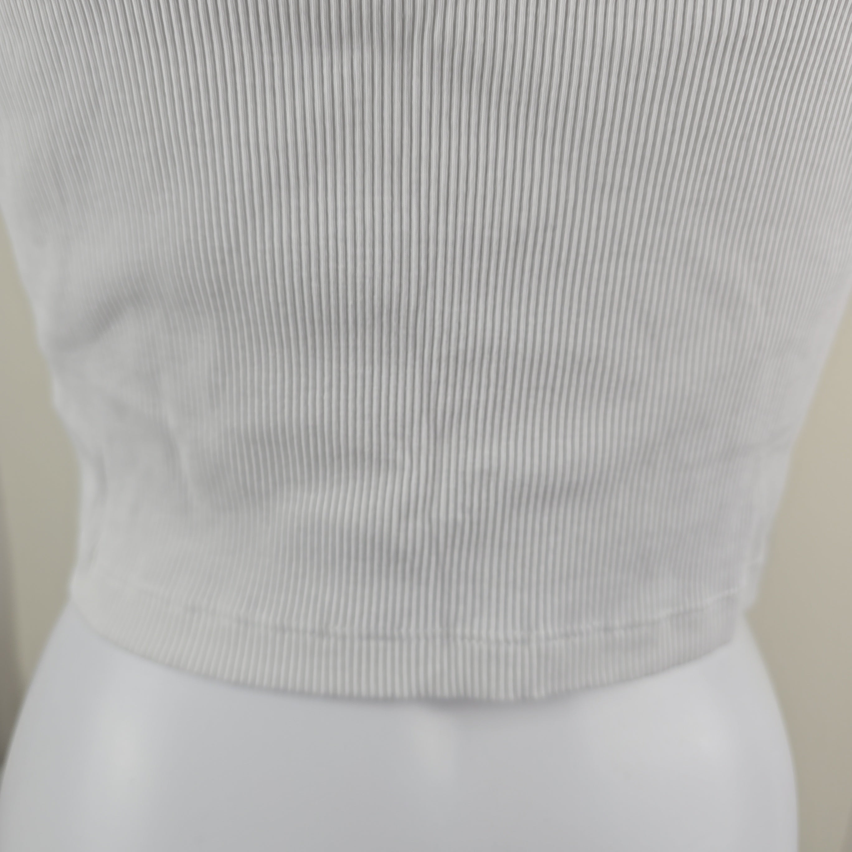 Close-up of a textured white fabric with a neutral background