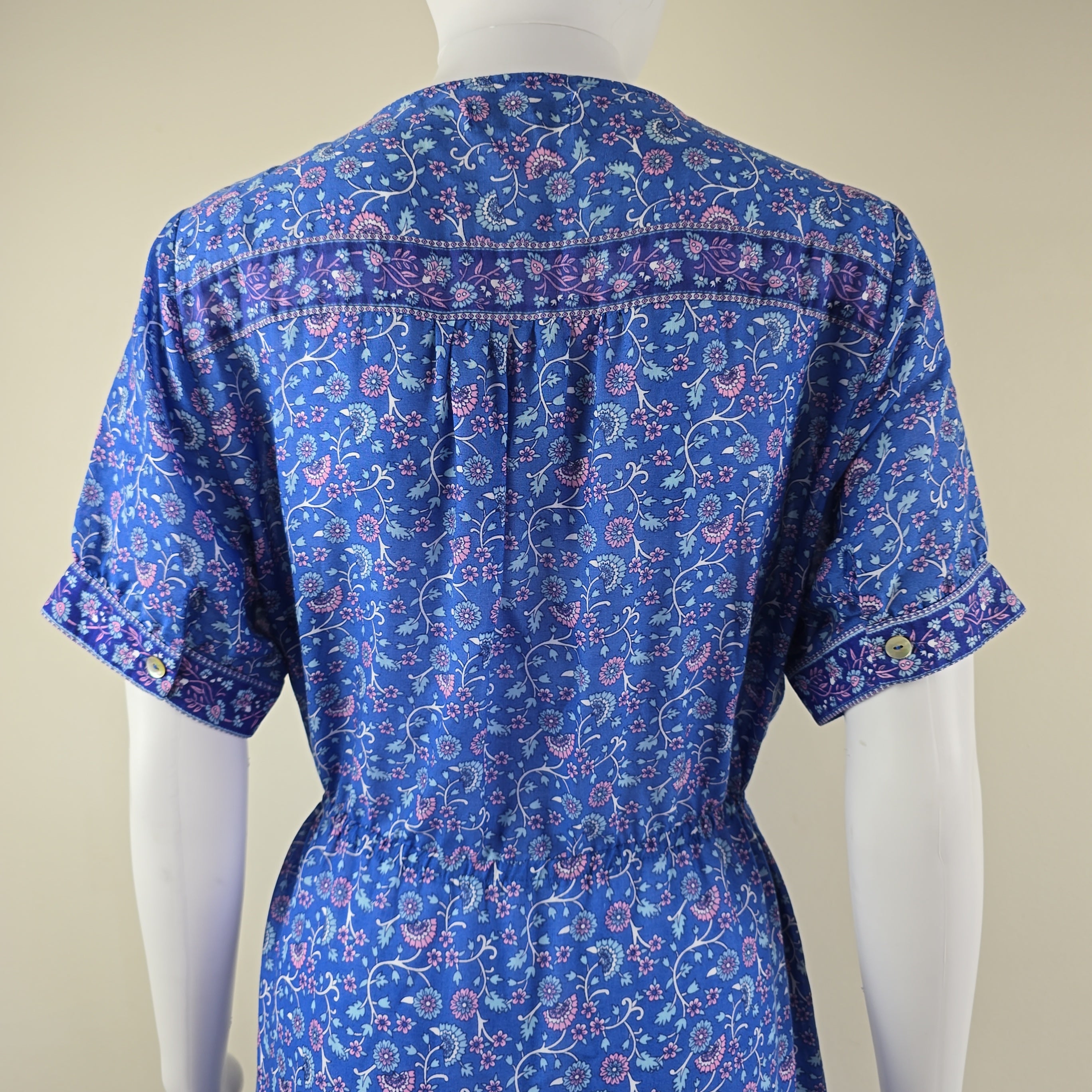 Blue patterned shirt against a beige background