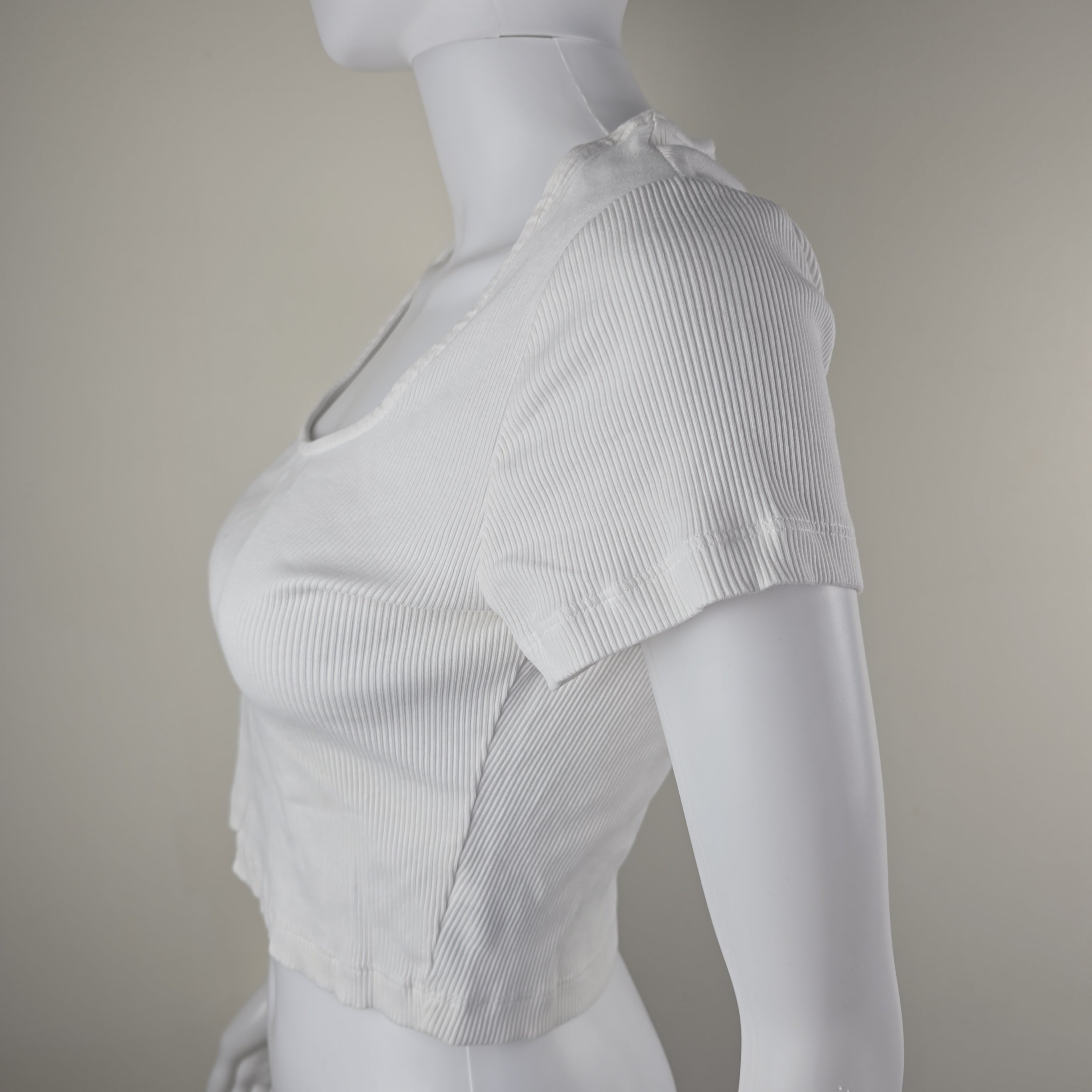 White ribbed tank top on a mannequin against a plain background
