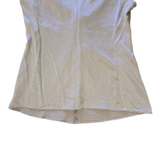 Beige top with a knot detail on alight floor