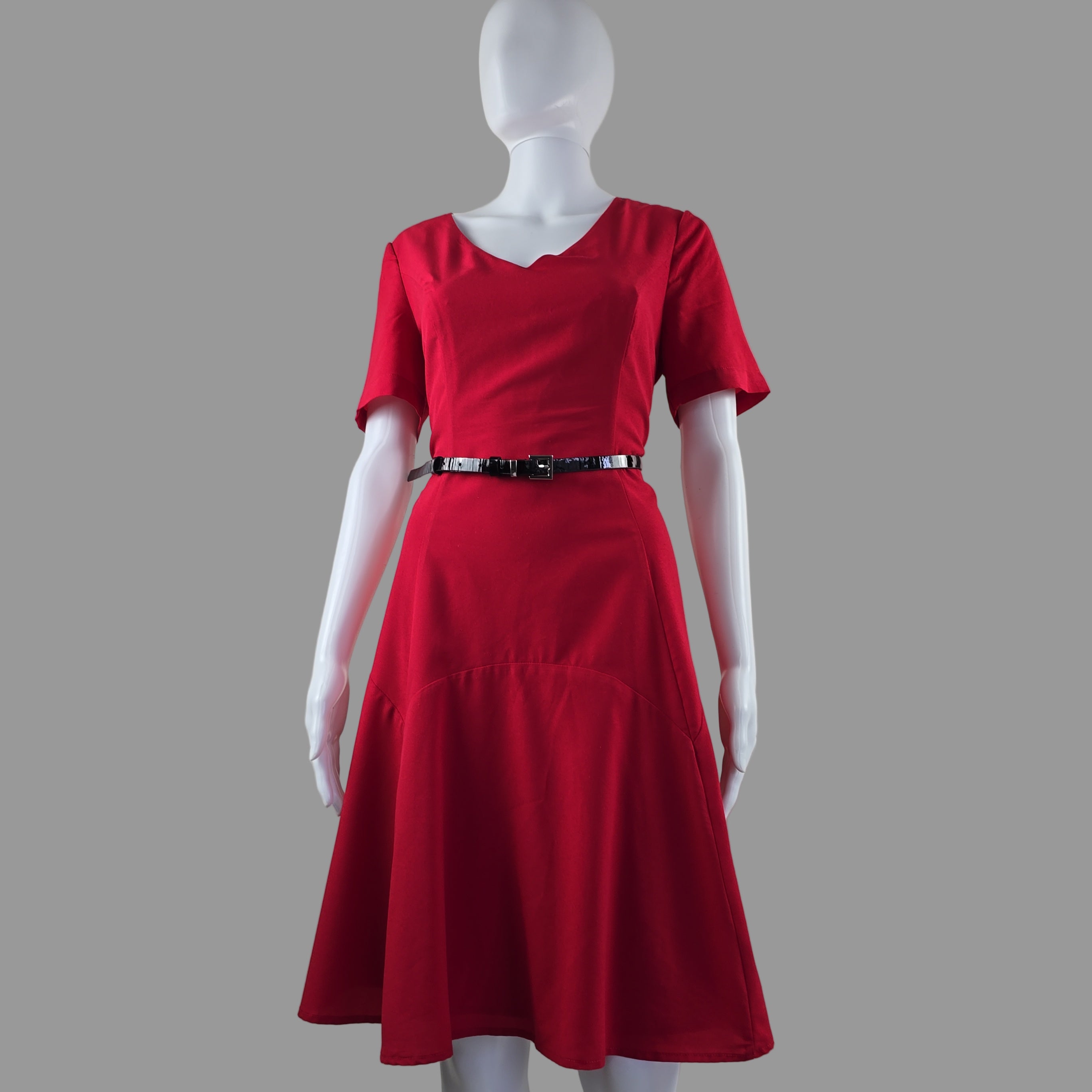 Red dress on a mannequin against a plain background