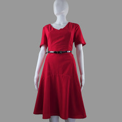 Red dress on a mannequin against a plain background