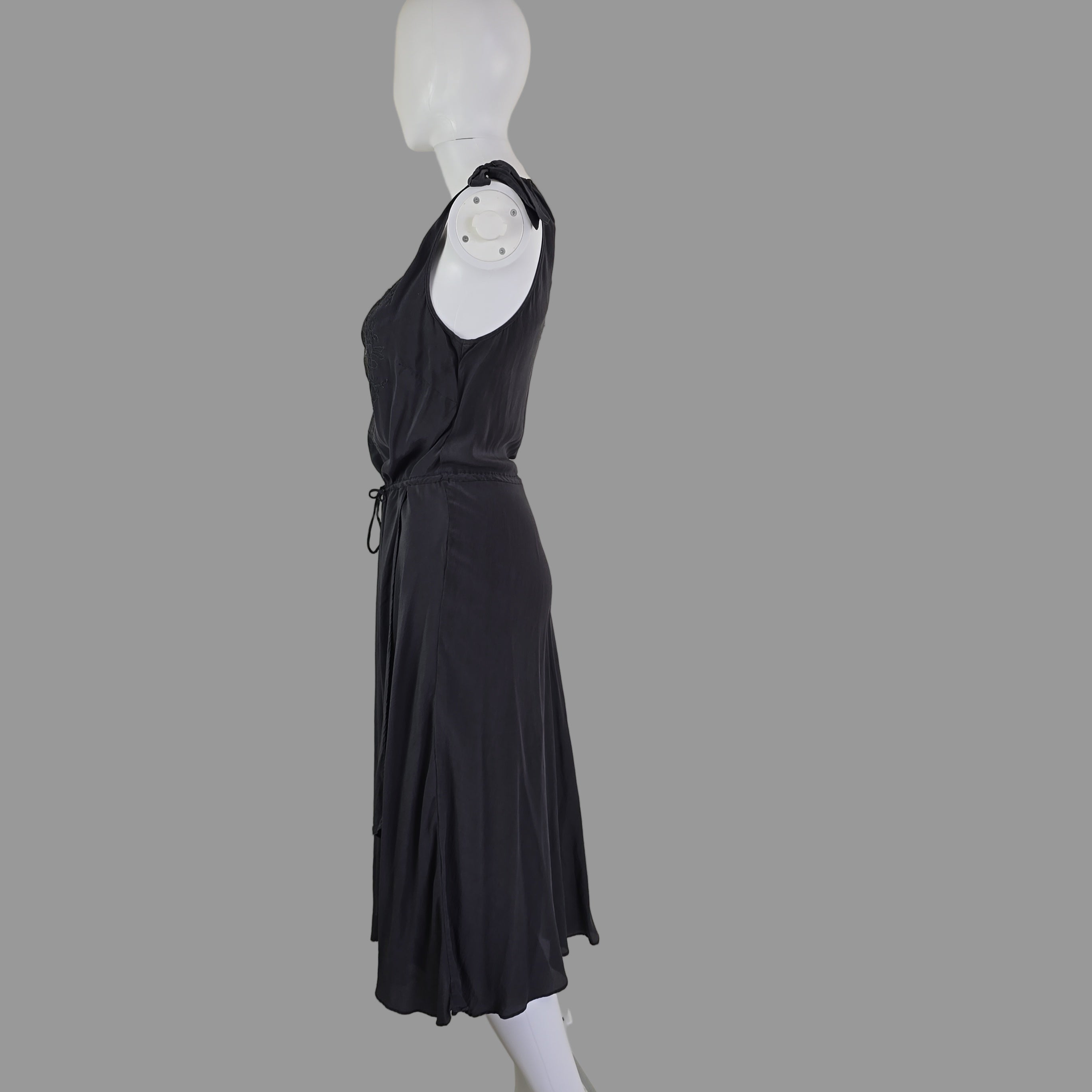 Grey dress on a mannequin against a plain background