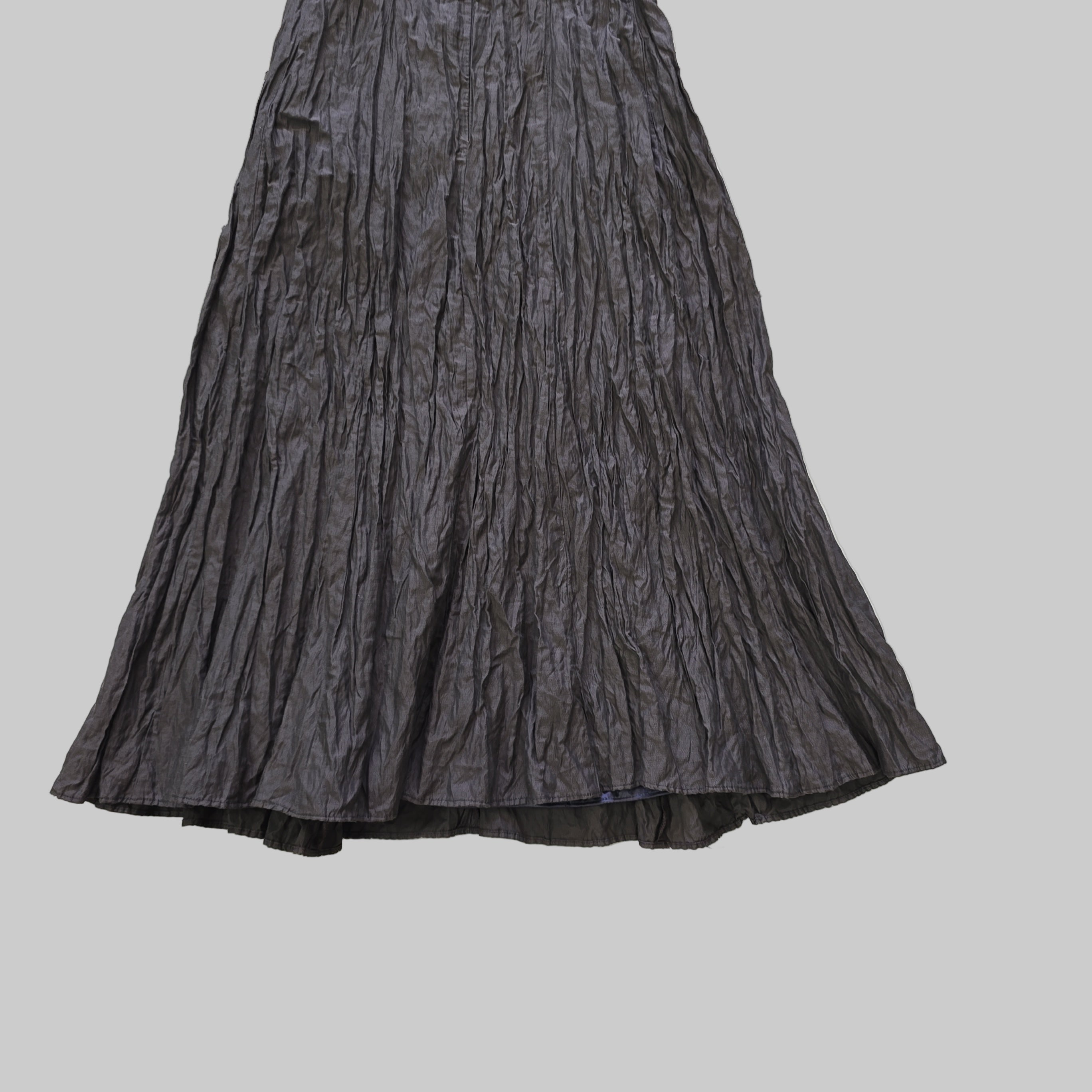 Dark gray pleated skirt on a tiled floor