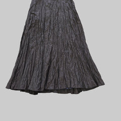 Dark gray pleated skirt on a tiled floor
