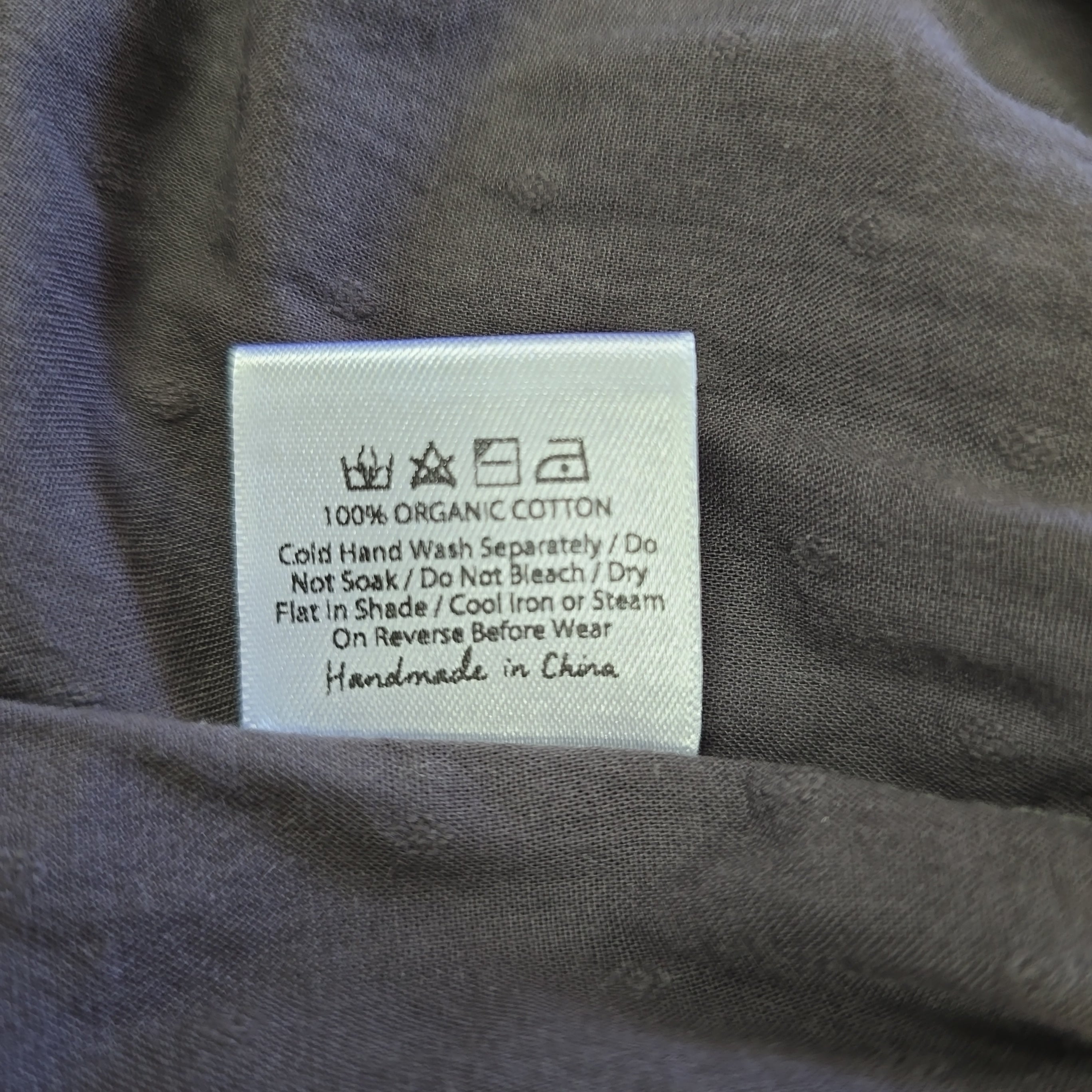 Clothing label on a gray fabric background