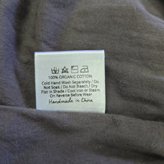 Clothing label on a gray fabric background