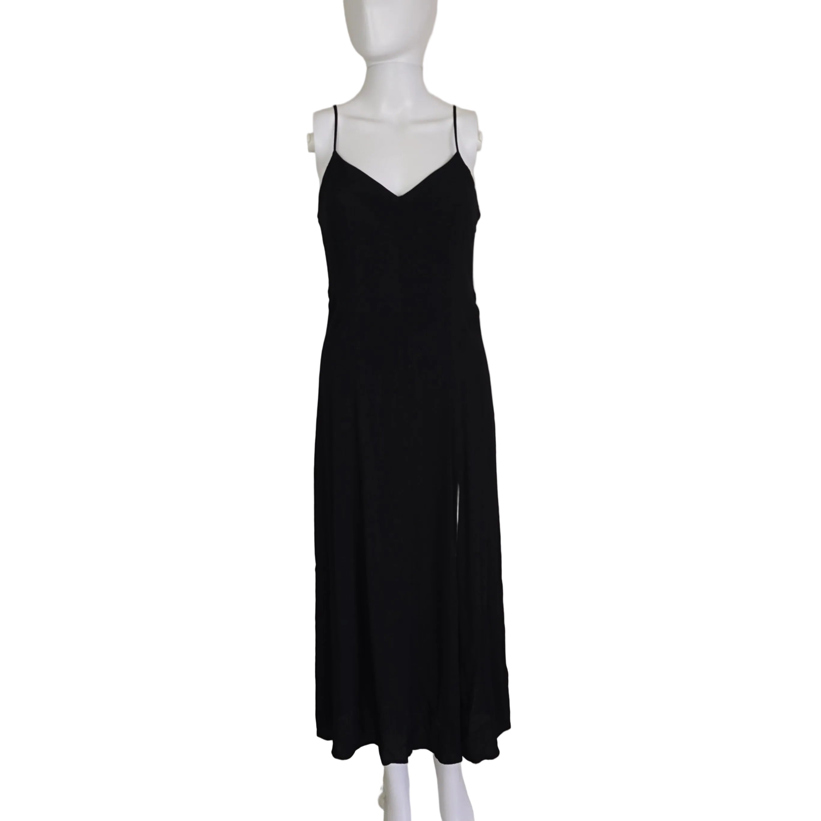 Black dress on a mannequin against a plain background