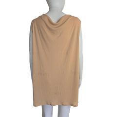 Mannequin wearing a beige top on a plain background