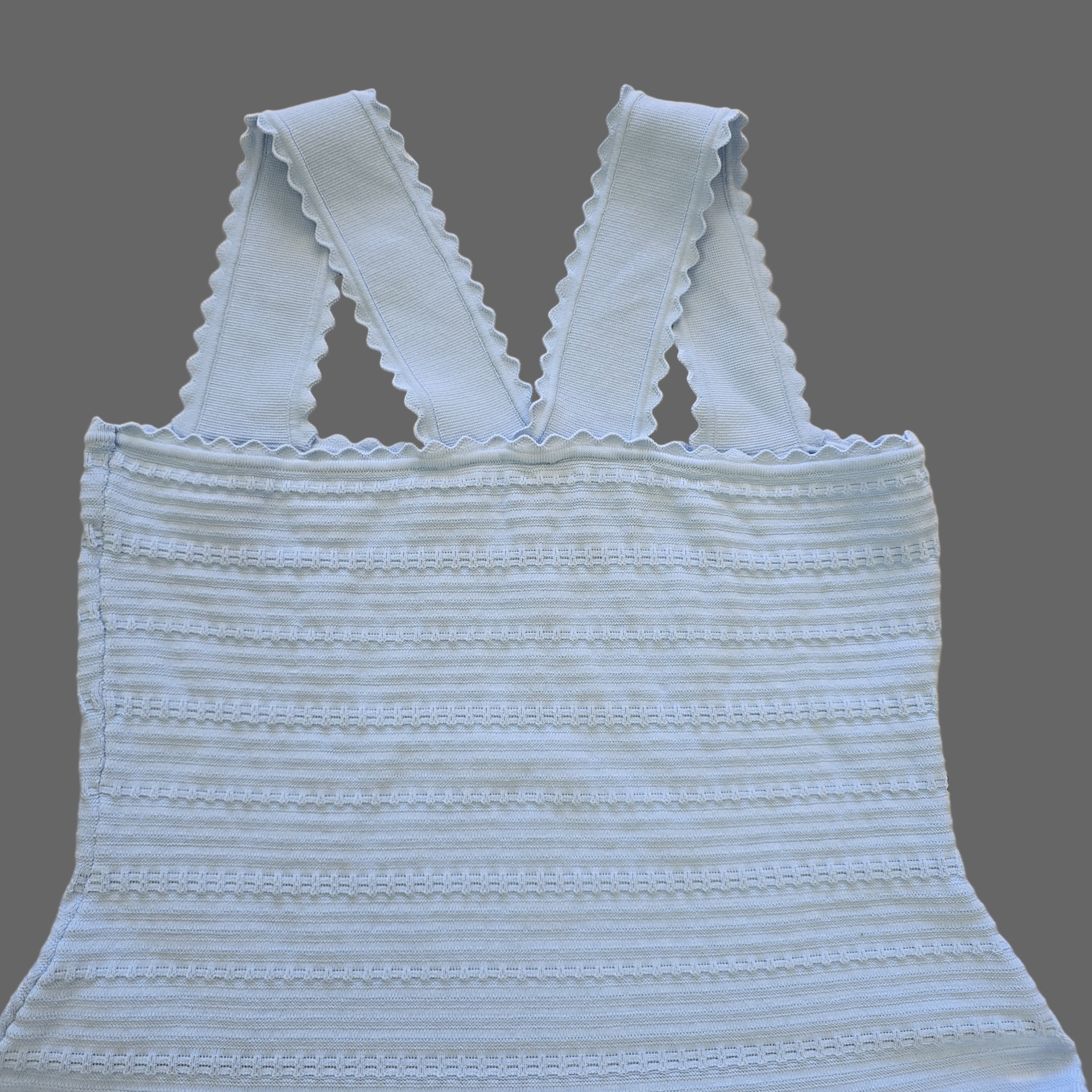 Light blue textured top on a beige tiled floor