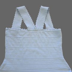 Light blue textured top on a beige tiled floor