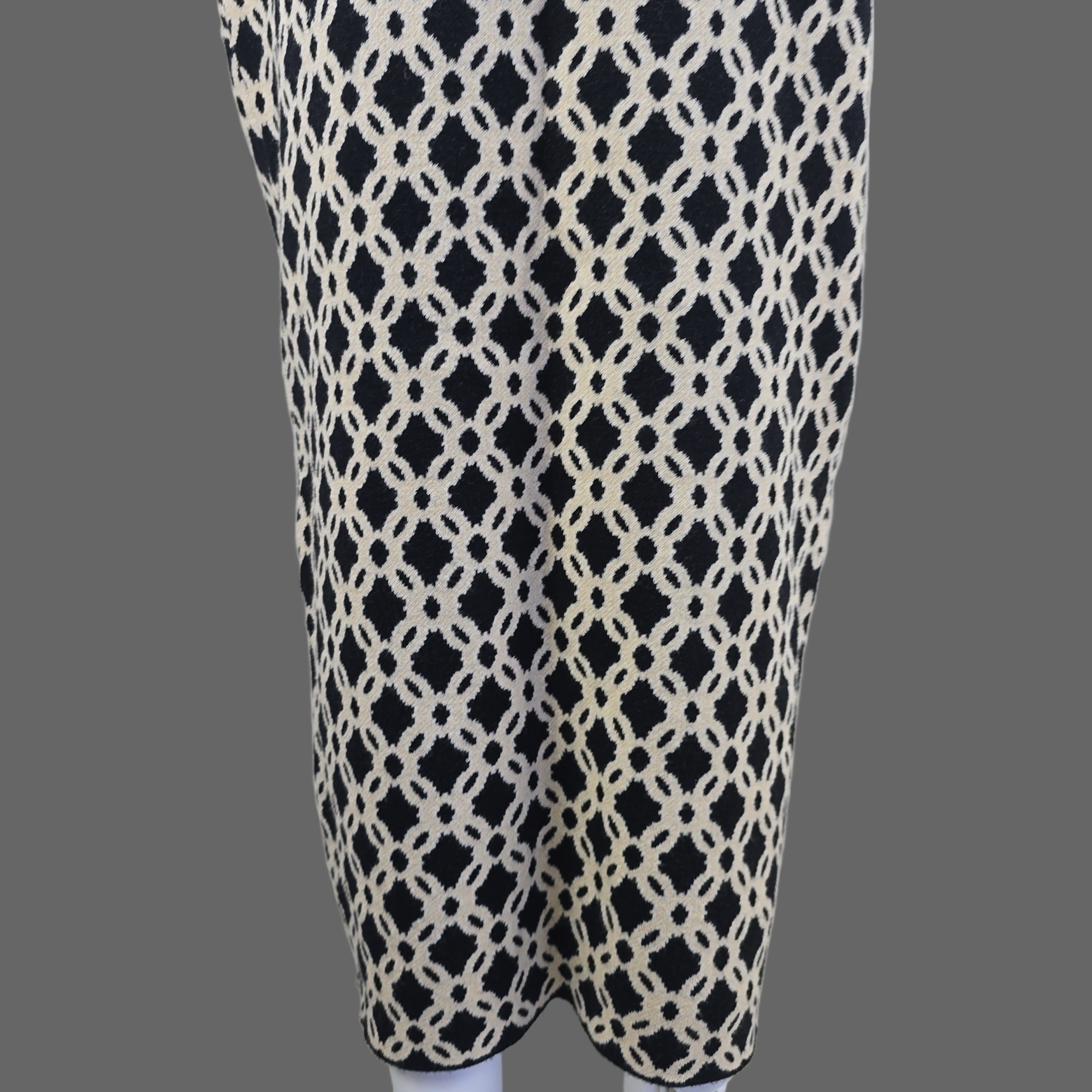 Black and white patterned skirt against a white wall