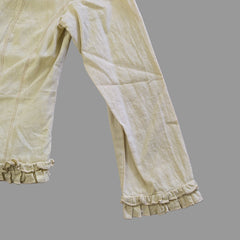 Light yellow jacket with frill details on a light background