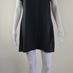 Mannequin wearing a black dress against a plain background