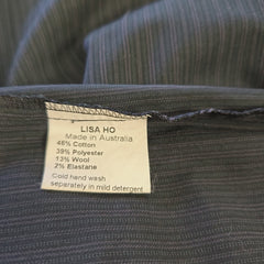 Close-up of a clothing label on a textured fabric background