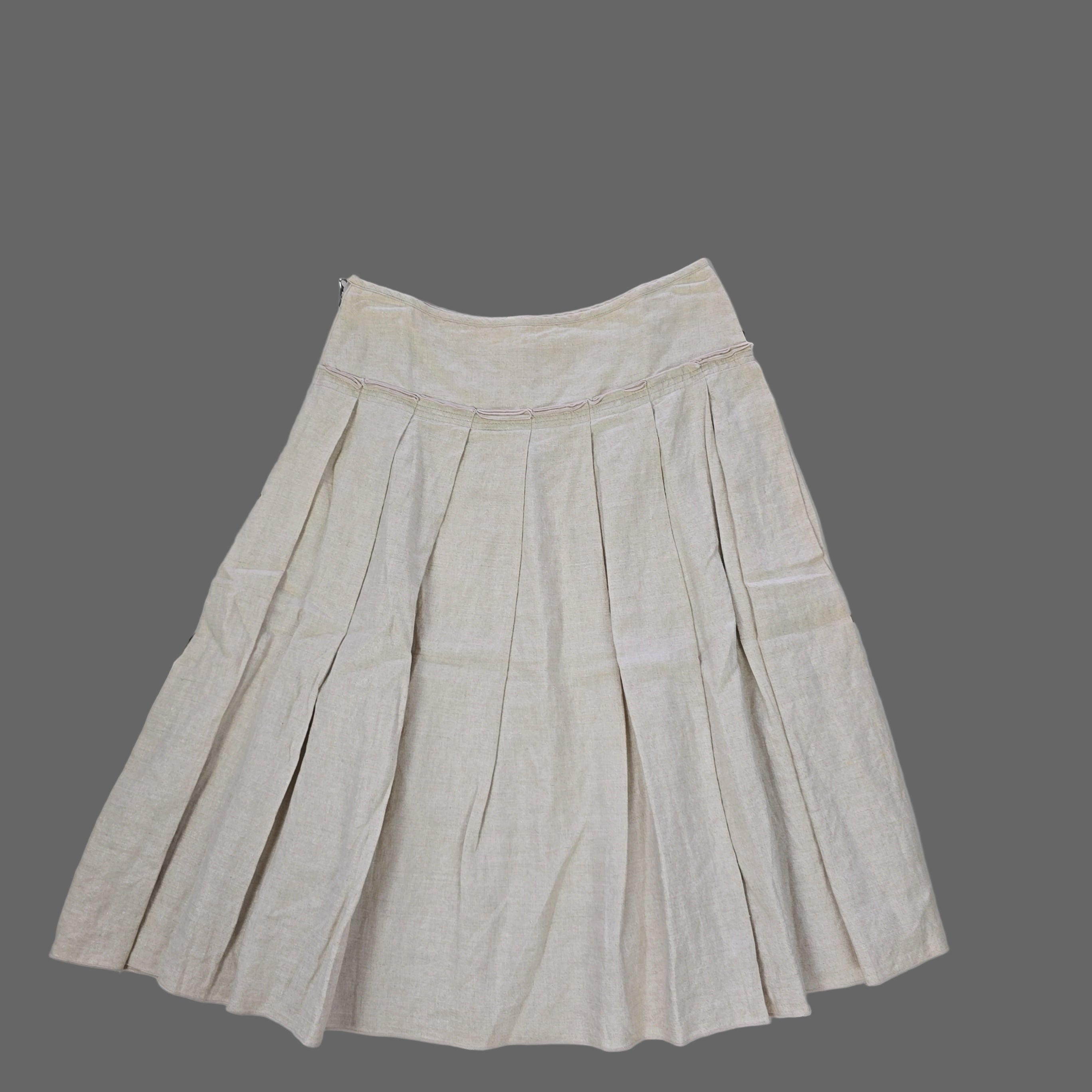 Beige pleated skirt on a tiled floor