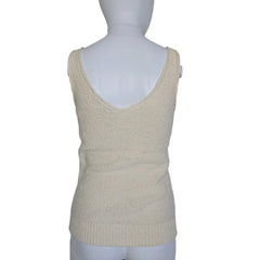 Mannequin wearing a beige knitted sleeve on a plain background