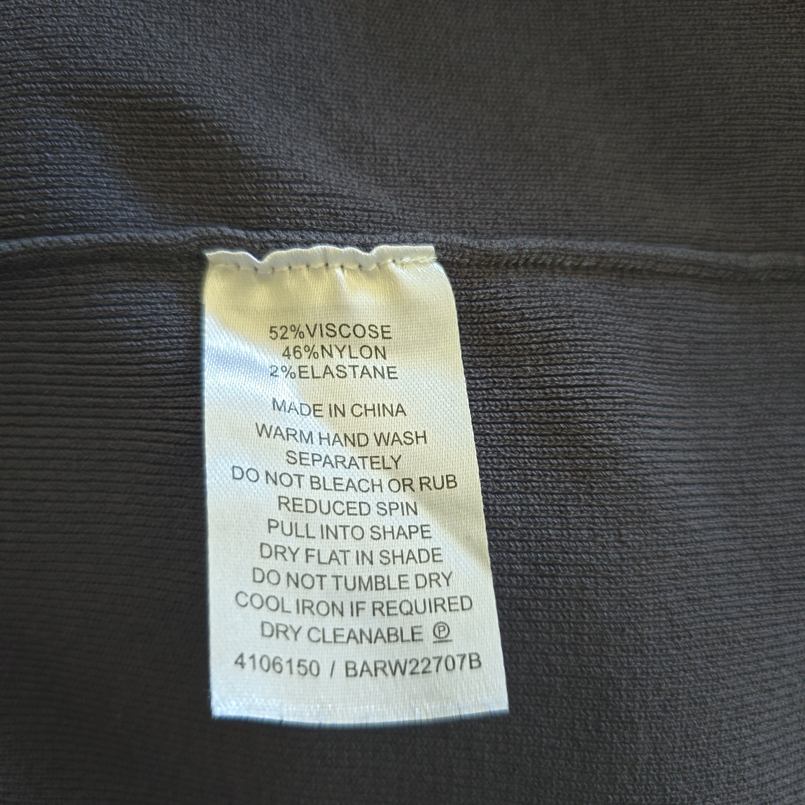 Clothing label on a dark fabric background