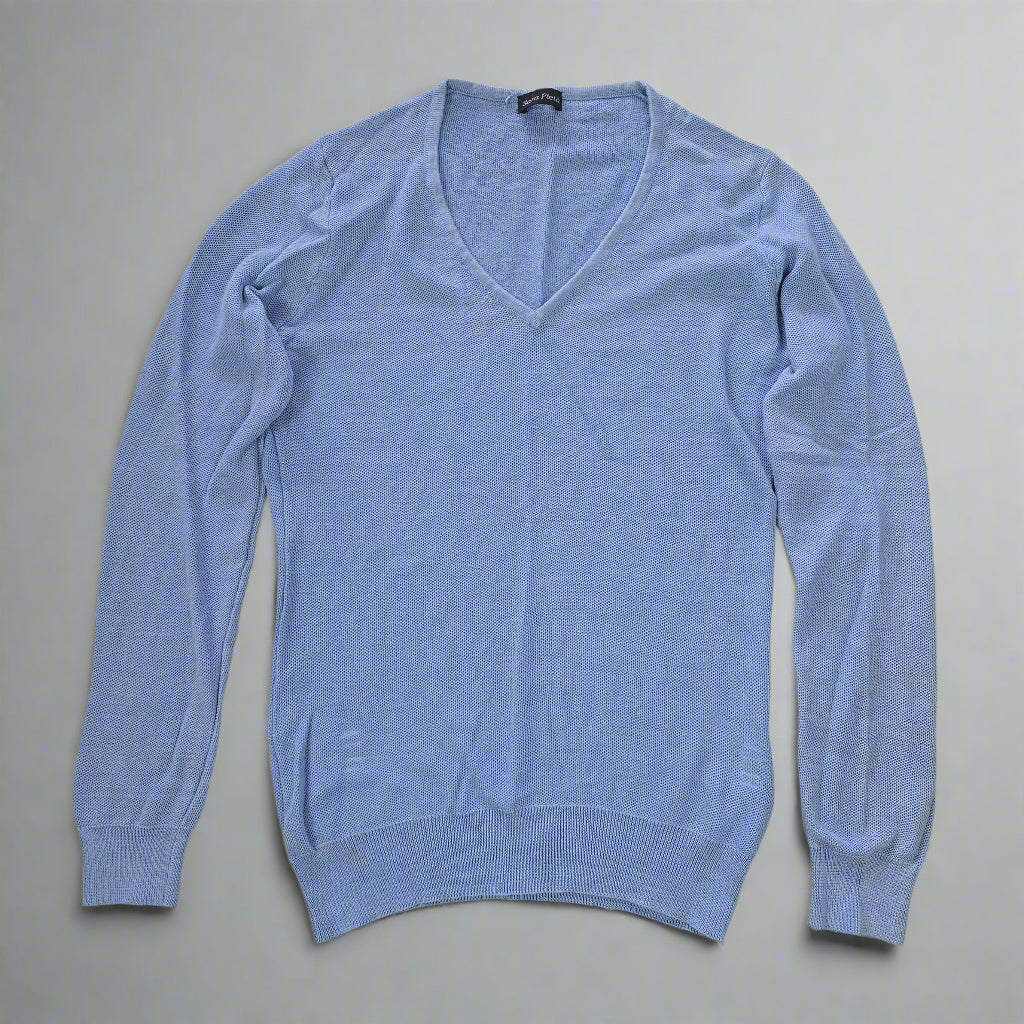 Blue sweater on a tiled floor