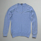 Blue sweater on a tiled floor