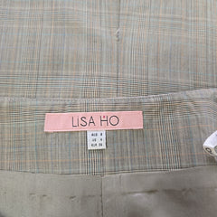 Plaid fabric with a pink label and white tag on a gray background