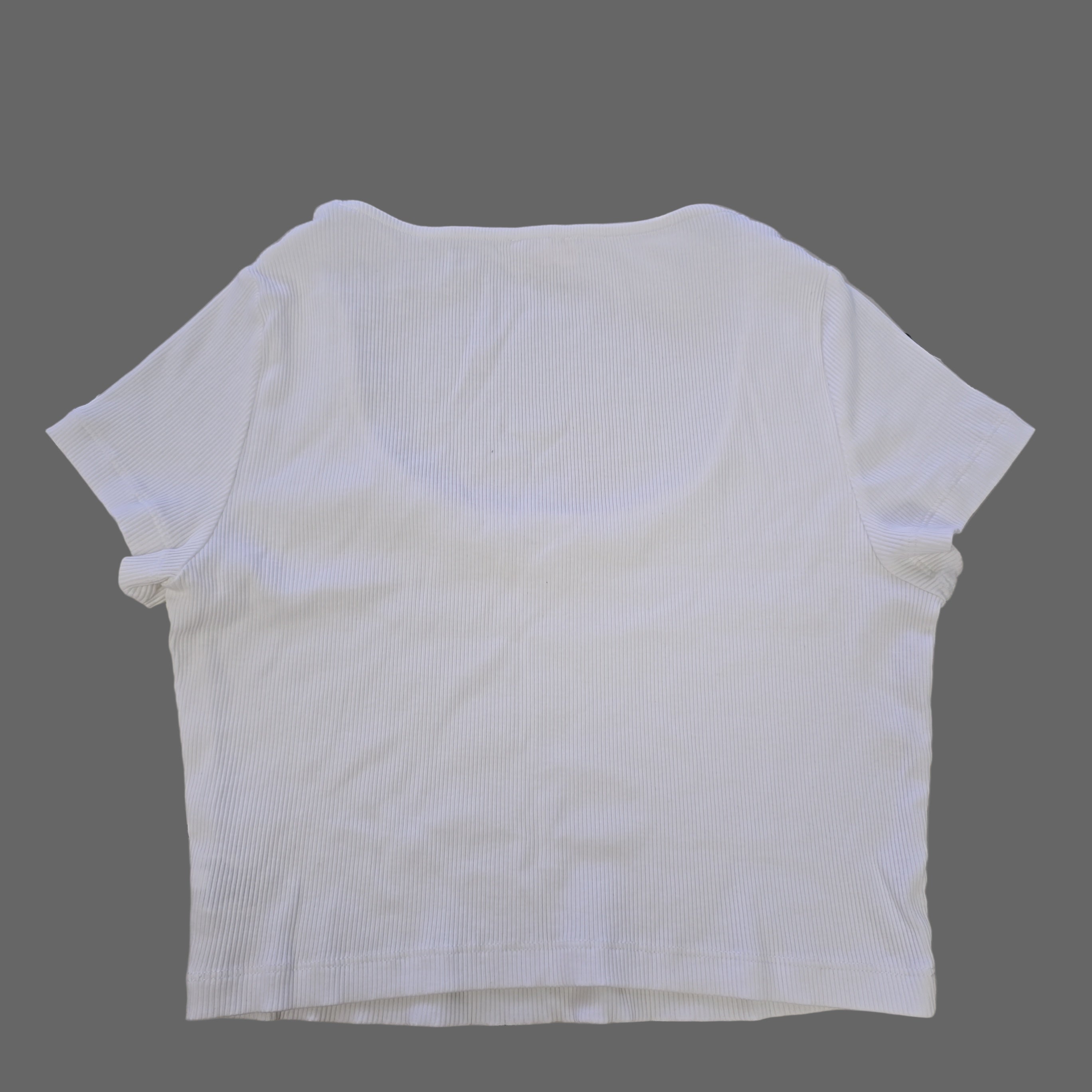 White top on a tiled floor