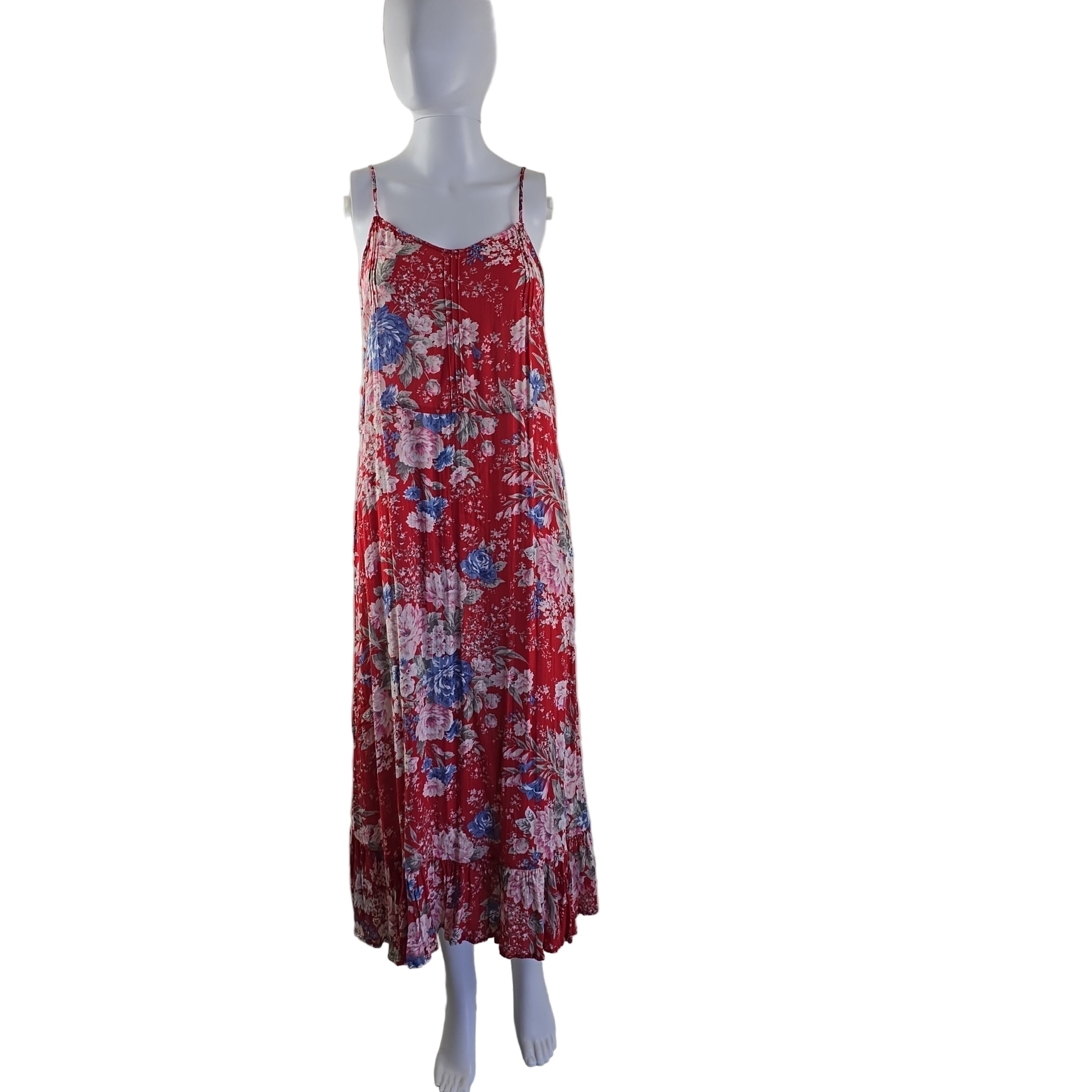 Red floral dress on a mannequin against a white wall.
