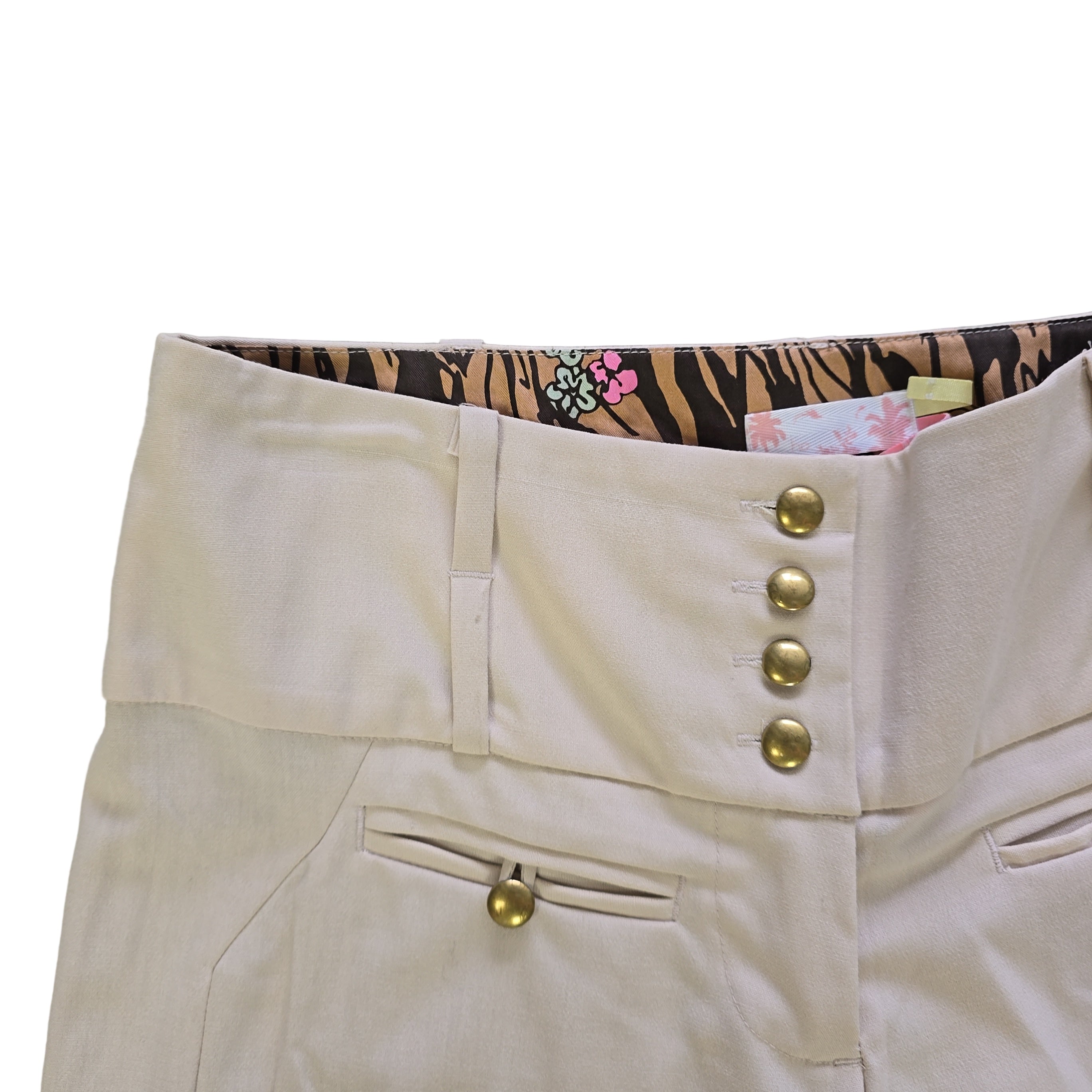 Beige pants with gold buttons on a white background